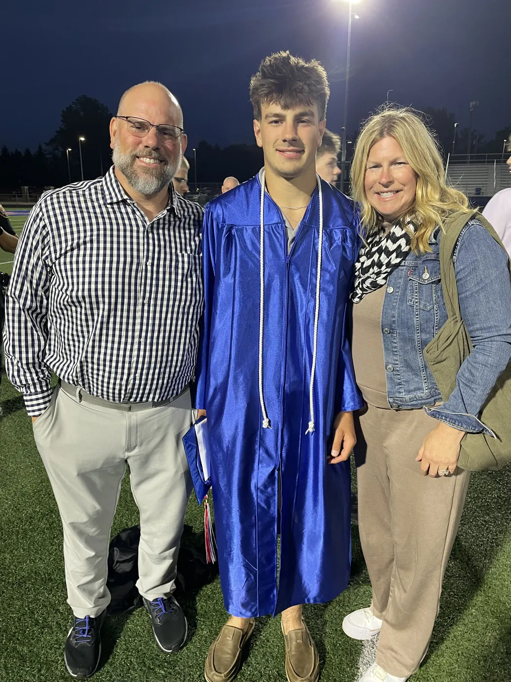 Harrison Drvenkar, founder of Grass 'n' Gardens, at his graduation with his parents.