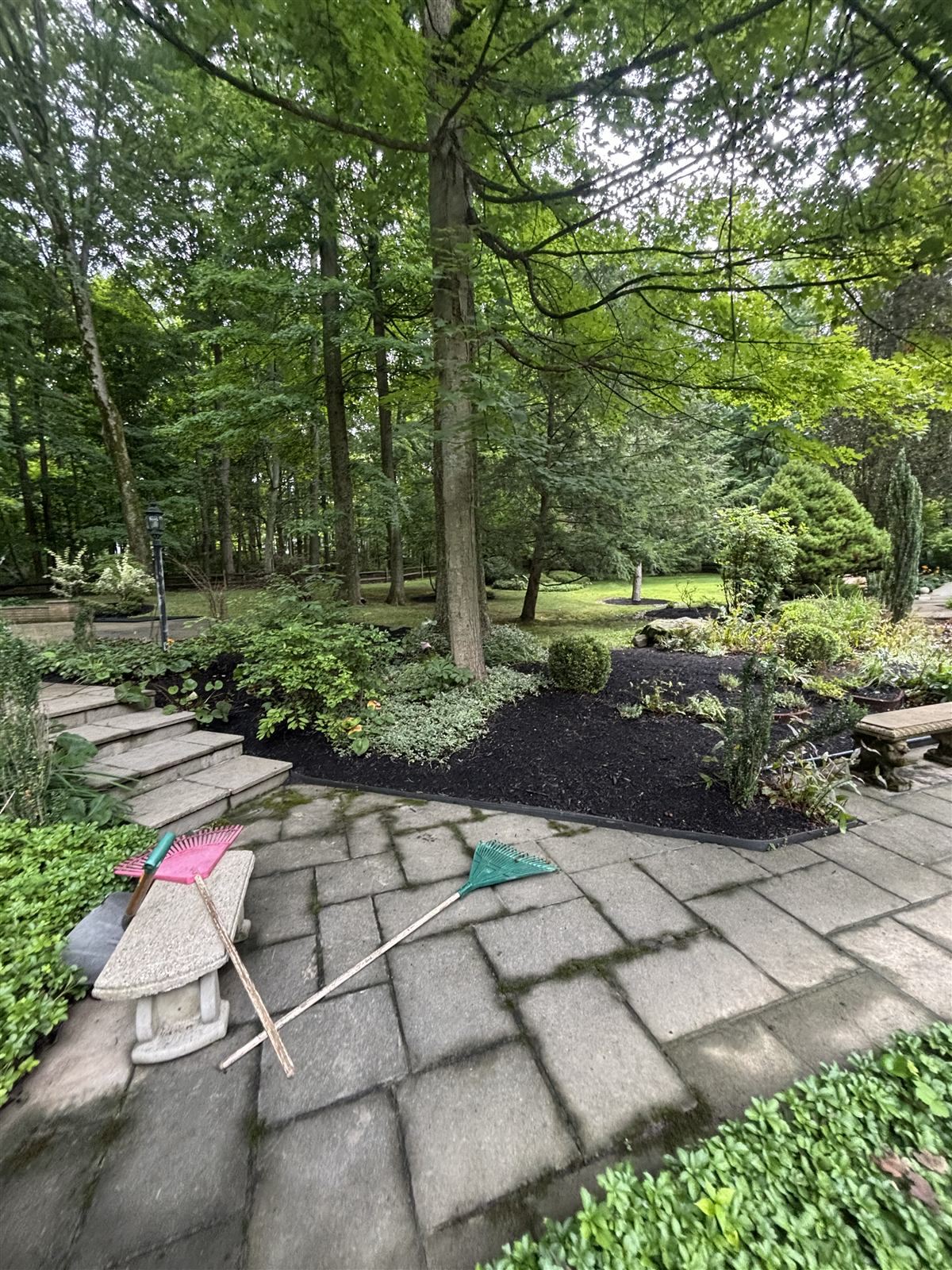 Beds and a stone walk cleared of leaves after a fall cleanup