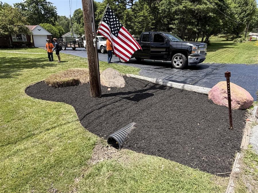 The Grass 'n' Gardens crew by the truck on a mulch job