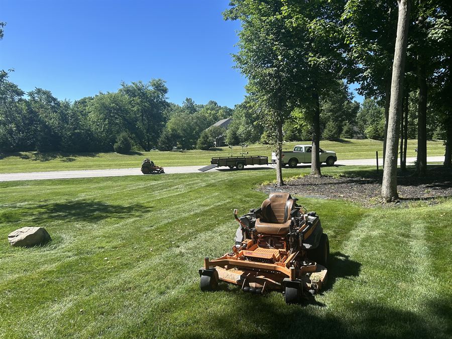 Stand-on mower on a freshly striped front lawn